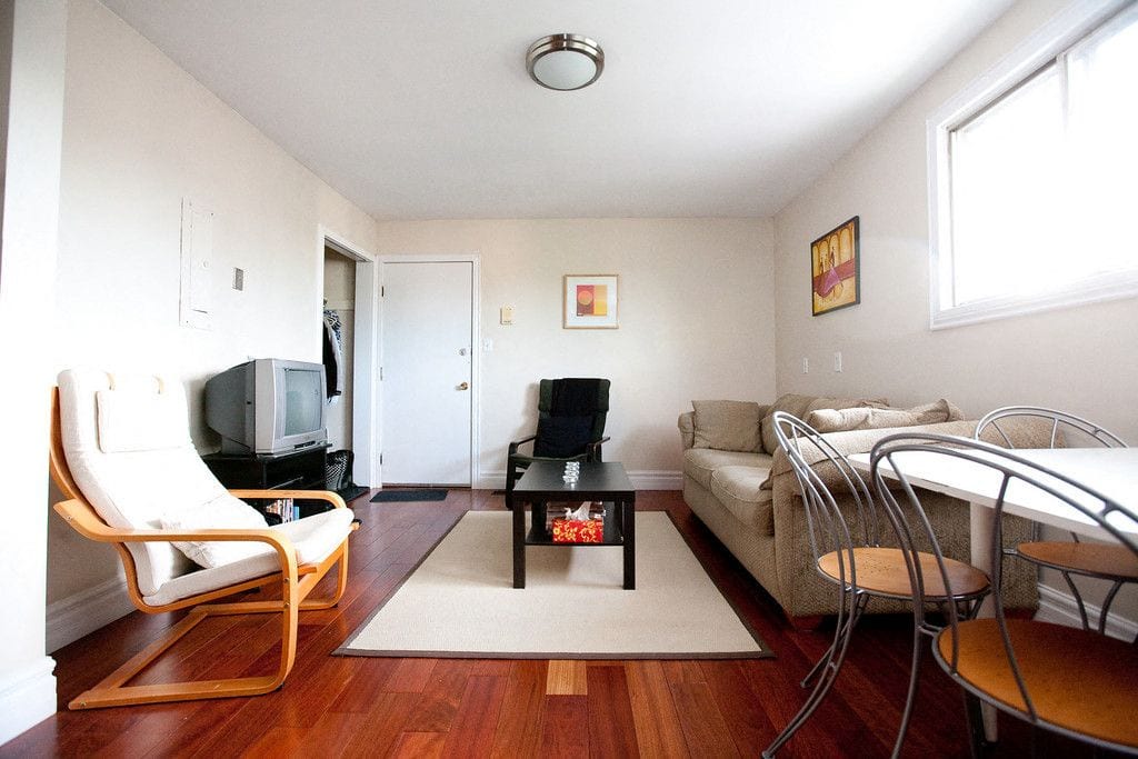 Shared living and dining room with hardwood floors at 353 Alfred Street
